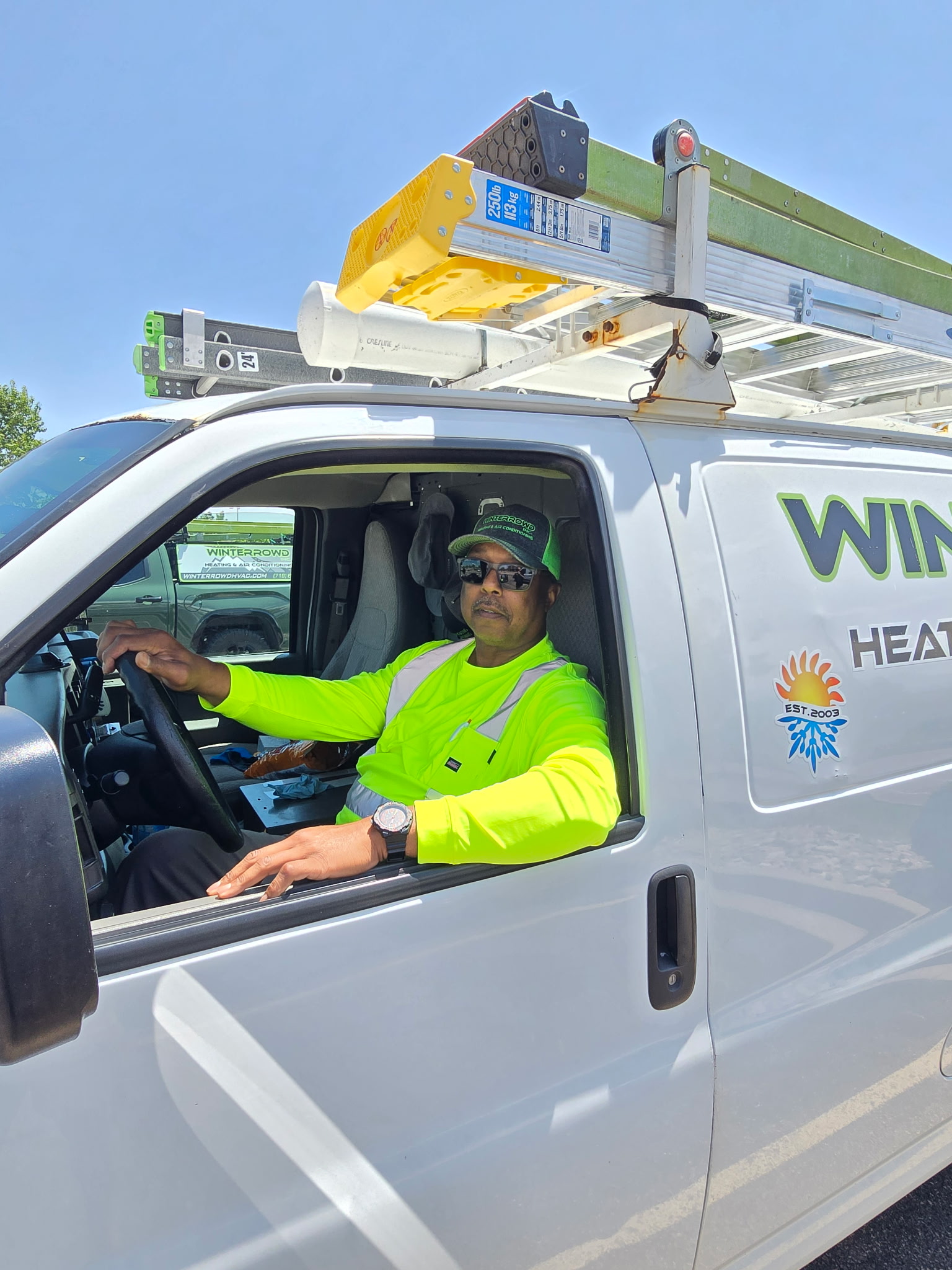 Winterrowd technician in a branded service van in Colorado Springs